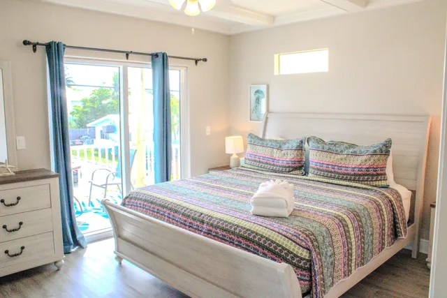 a bedroom with bed and wooden floor