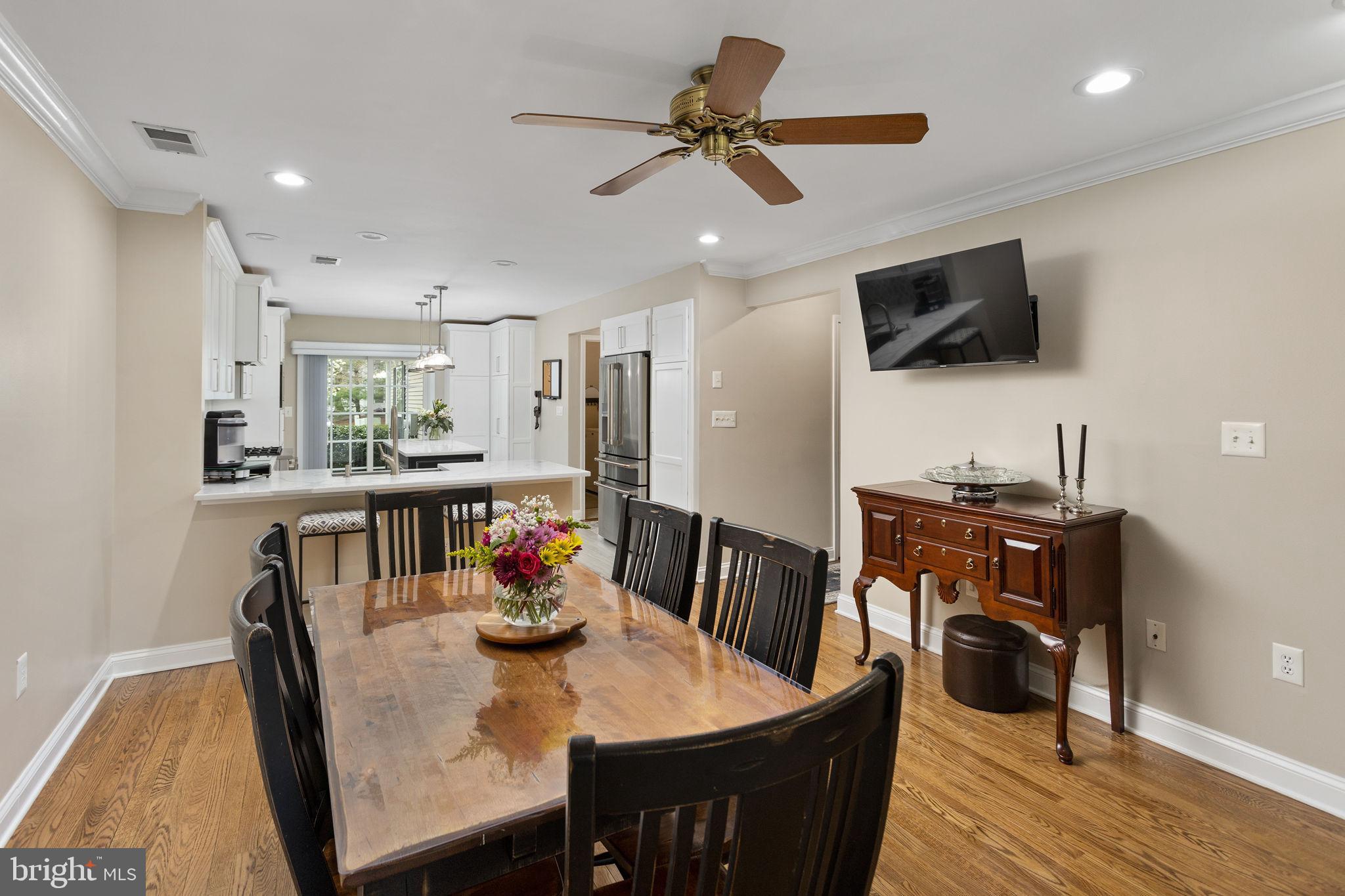 243 Colt Street Pennington, NJ 08534 - Photo 17 of 46 a view of a dining room with furniture and a flat screen tv