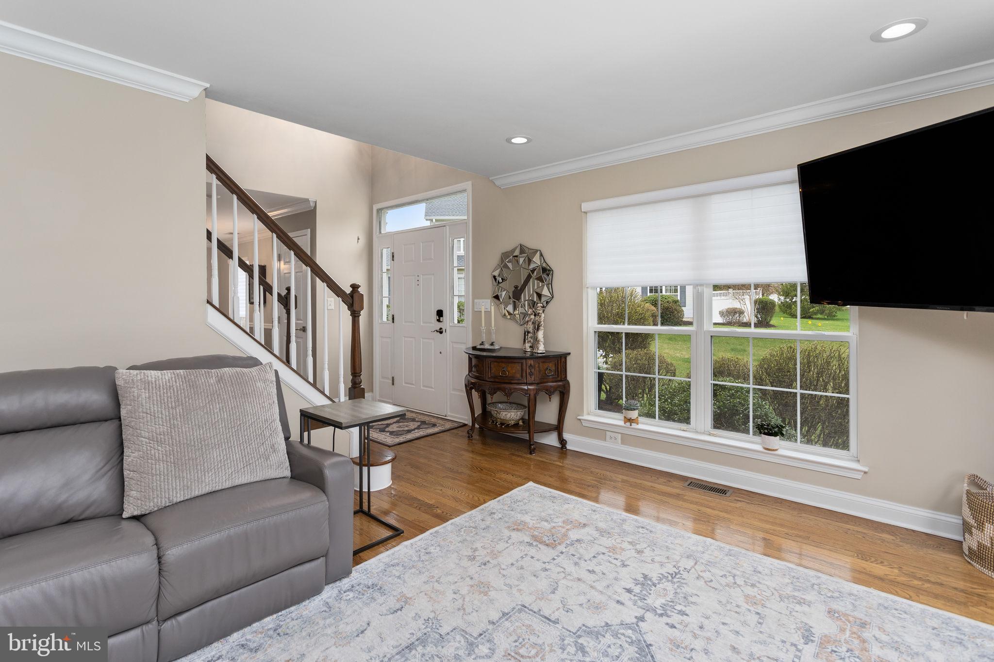 243 Colt Street Pennington, NJ 08534 - Photo 20 of 46 a living room with furniture tv and a floor to ceiling window