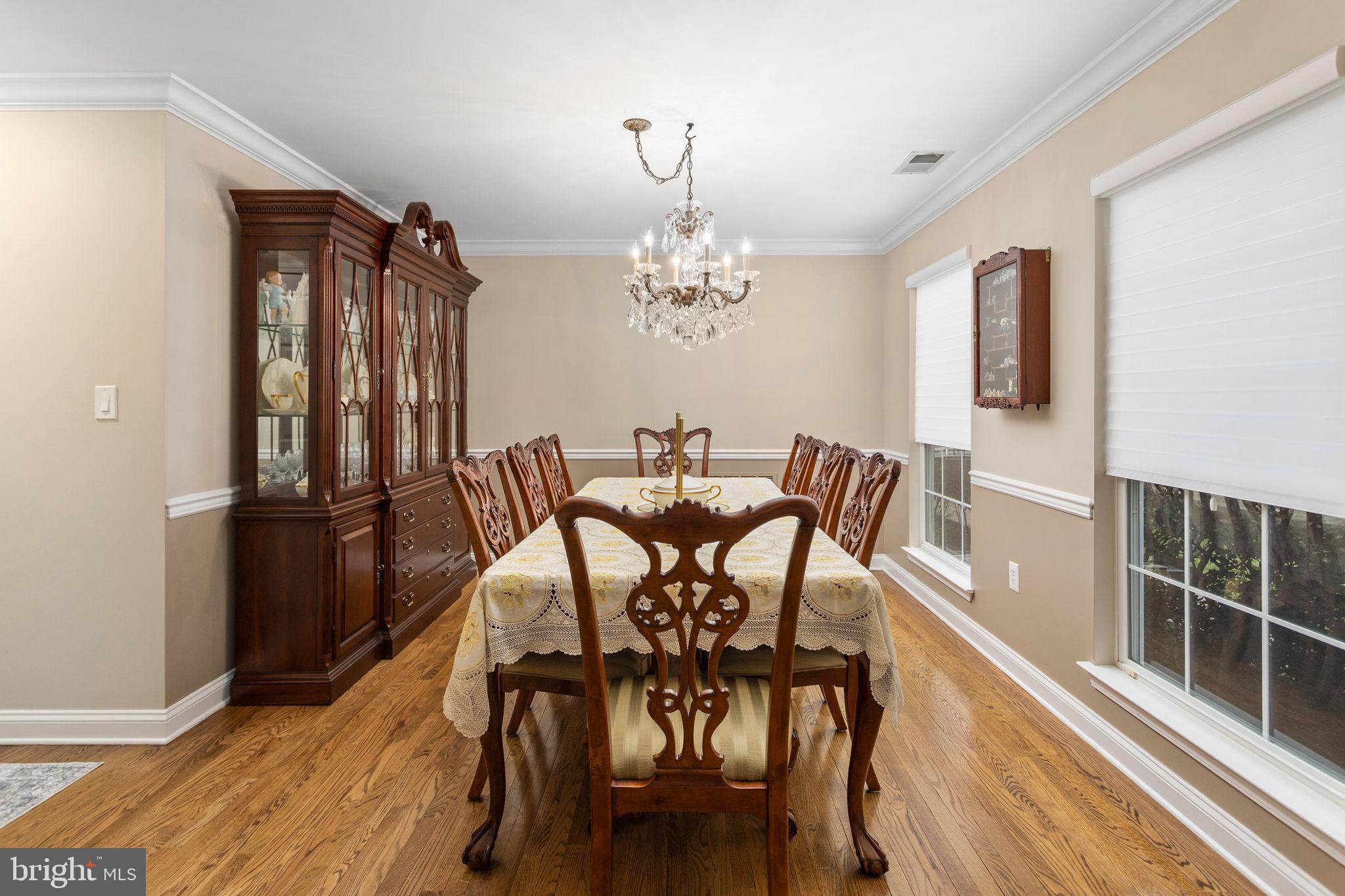 243 Colt Street Pennington, NJ 08534 - Photo 21 of 46 a view of a dining room with furniture and chandelier