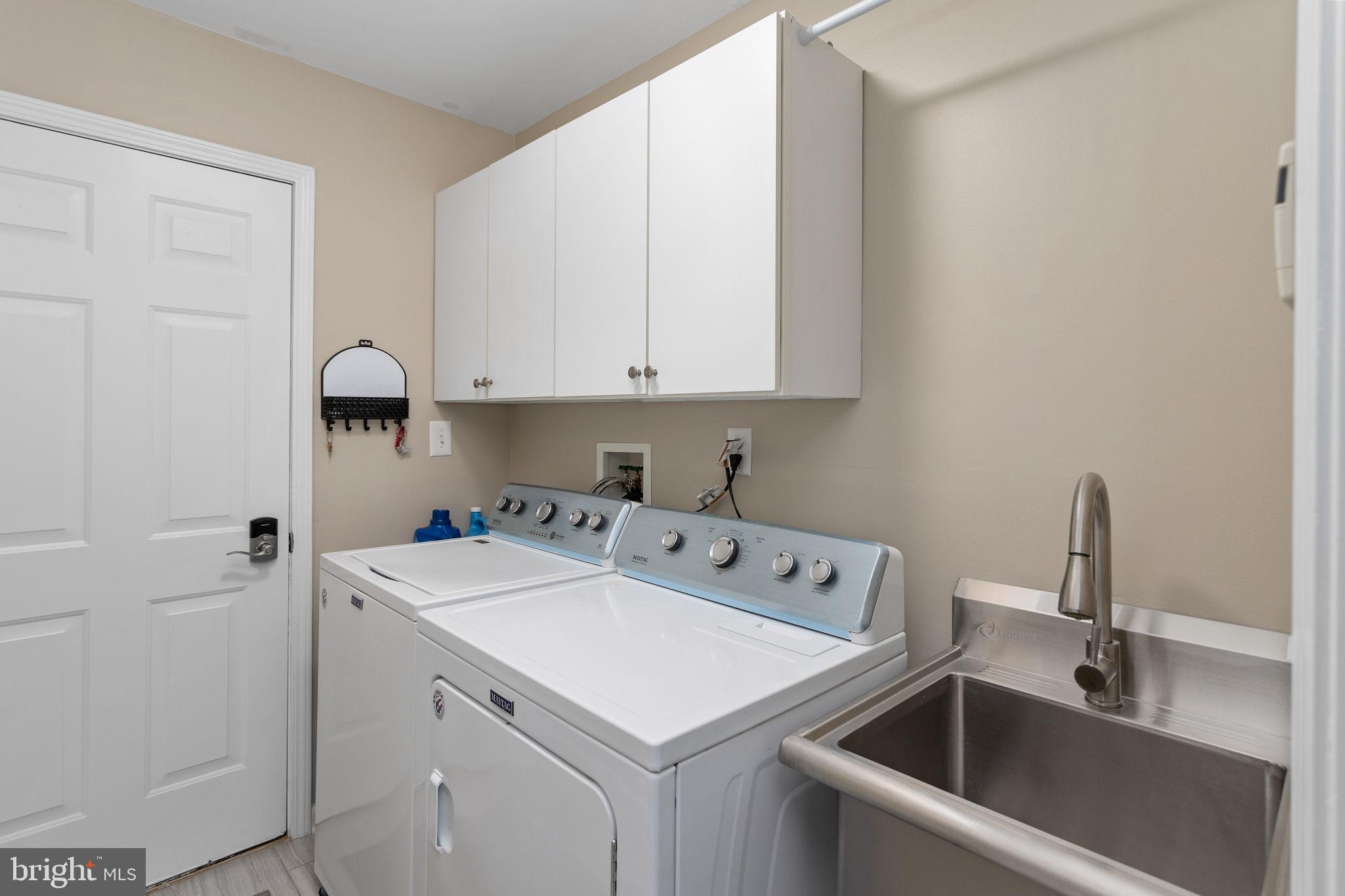 243 Colt Street Pennington, NJ 08534 - Photo 24 of 46 a utility room with sink dryer and washer