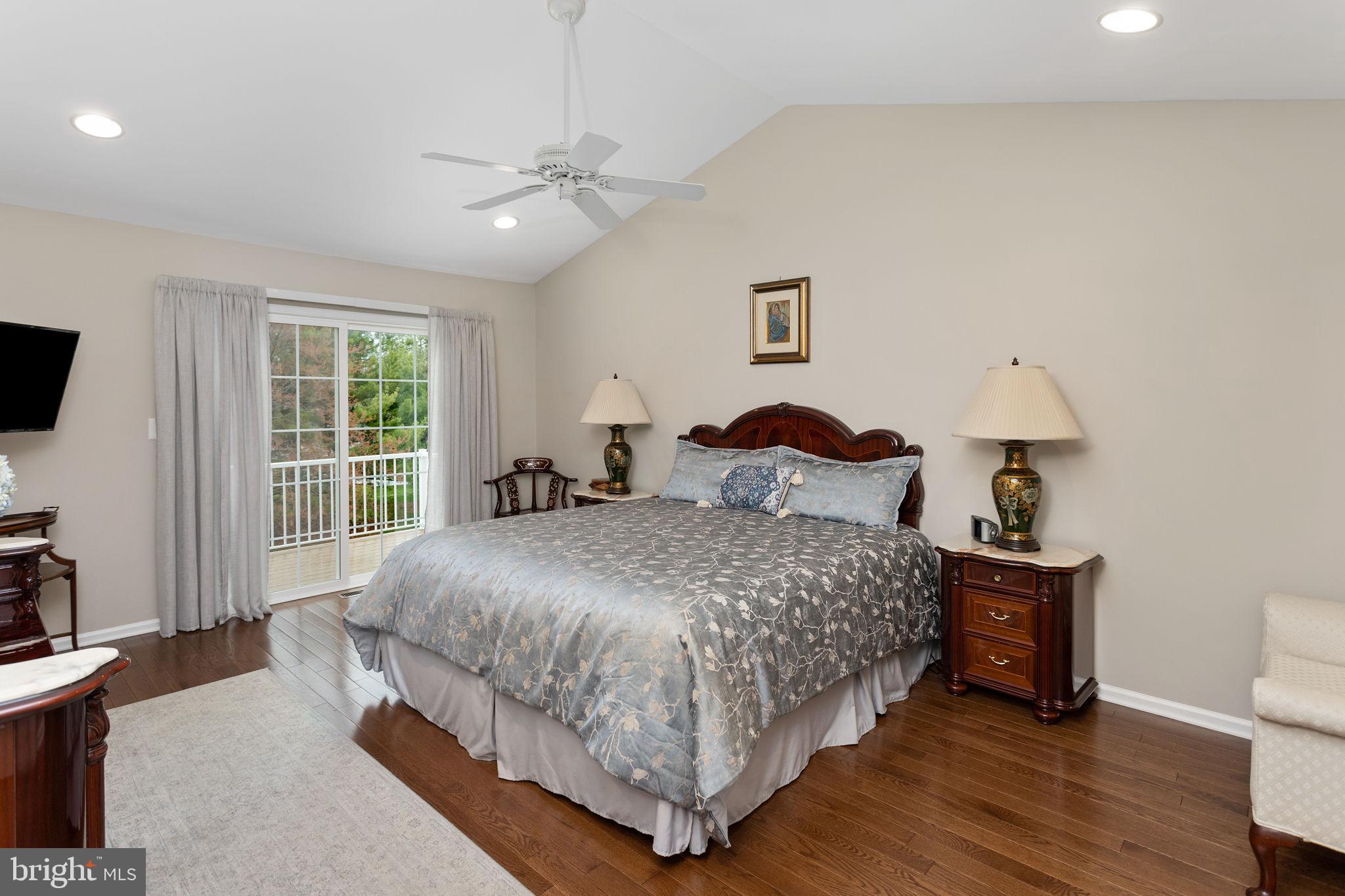 243 Colt Street Pennington, NJ 08534 - Photo 29 of 46 a bedroom with a bed and a flat tv screen on dresser