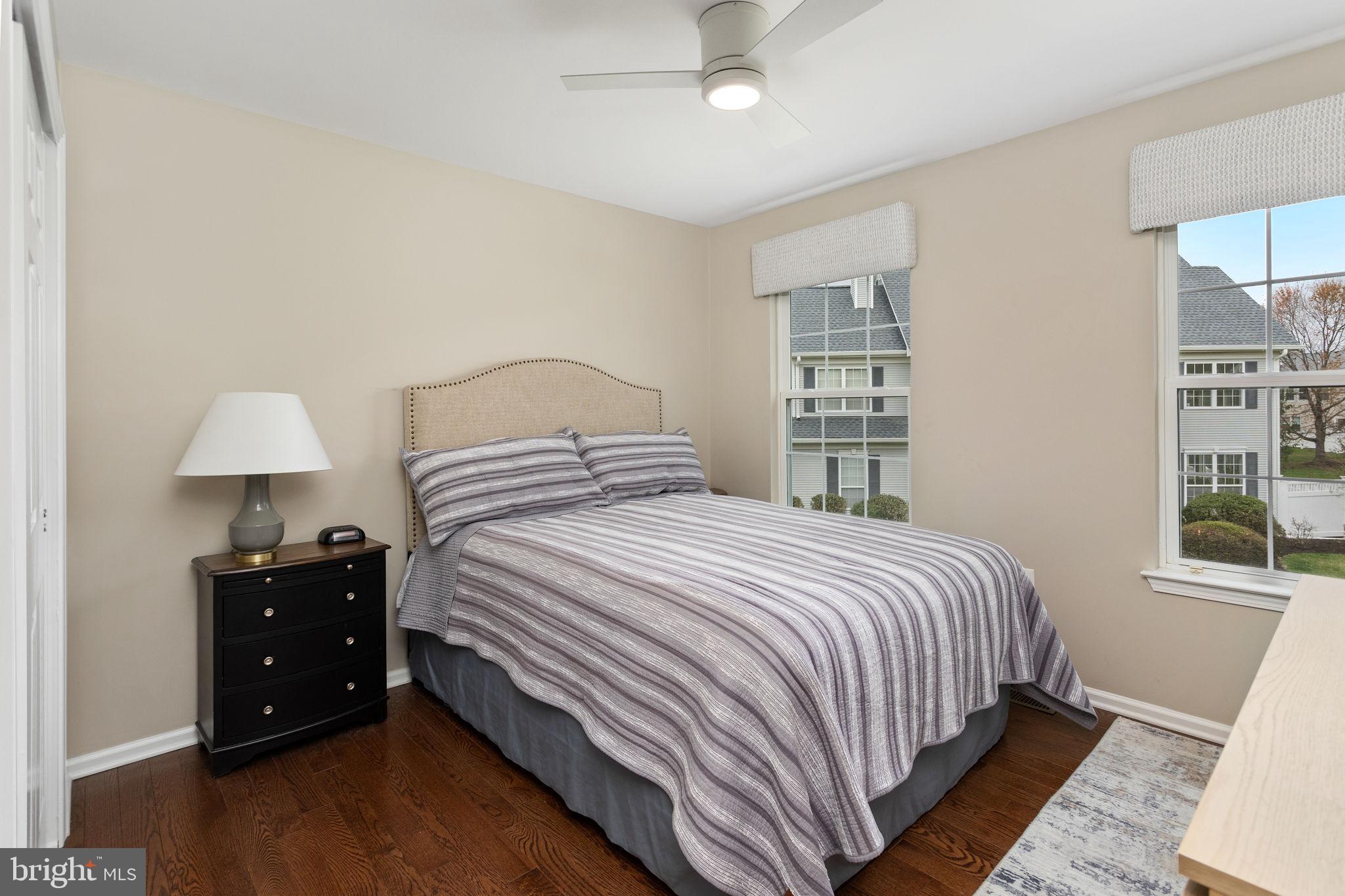 243 Colt Street Pennington, NJ 08534 - Photo 34 of 46 a bedroom with a bed and a chandelier