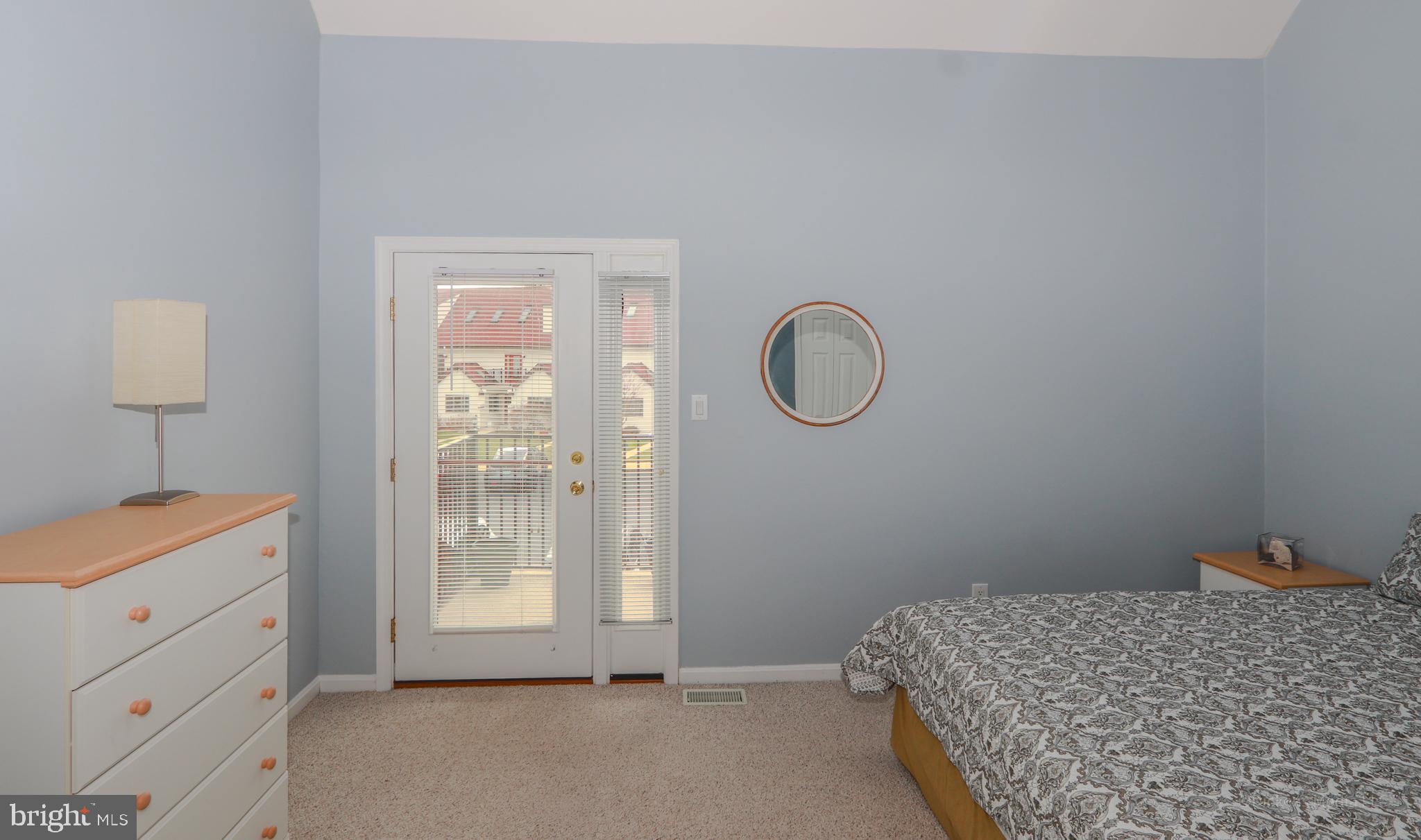 15 Queen Anne Way, Unit E Chester, MD 21619 - Photo 13 of 18 a bedroom with a bed and a window
