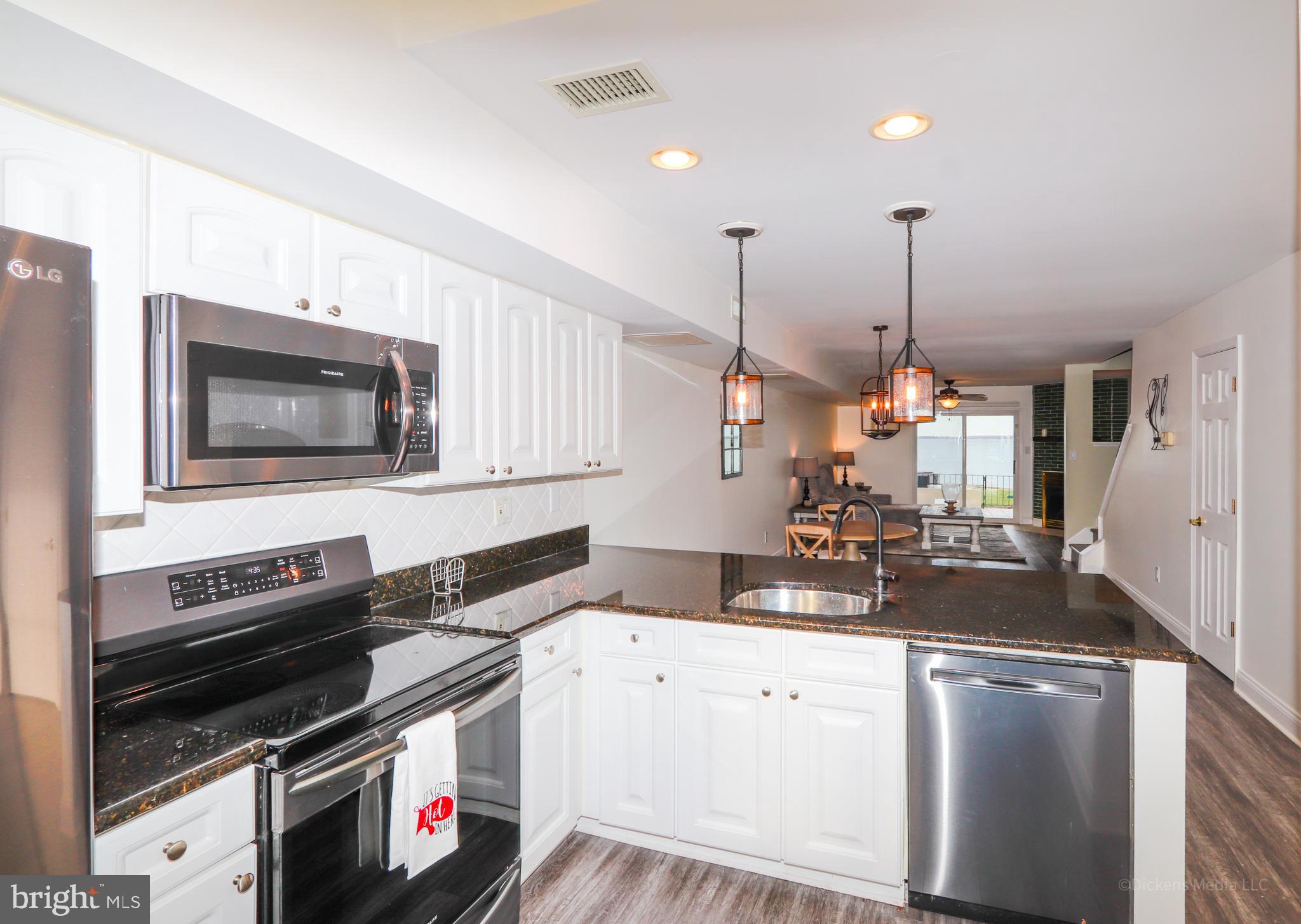 15 Queen Anne Way, Unit E Chester, MD 21619 - Photo 6 of 18 a kitchen with a stove and a sink