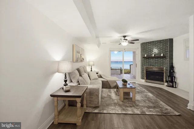 a dining room with wooden floor a chandelier a wooden table and chairs
