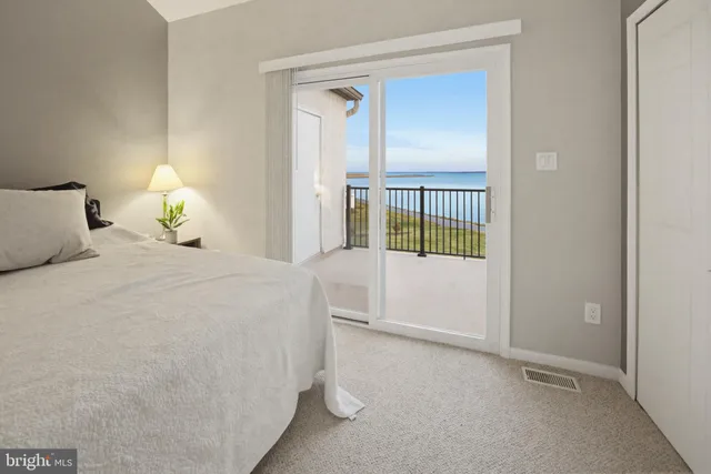 a bedroom with a large bed and a wooden floor