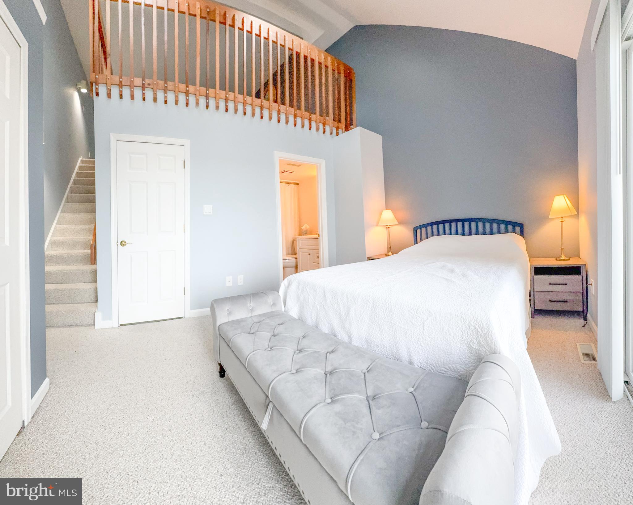 15 Queen Anne Way, Unit E Chester, MD 21619 - Photo 10 of 18 a bedroom with a large bed and a wooden floor