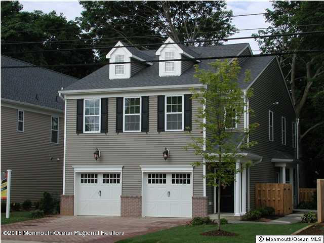222 Bridge Avenue Red Bank, NJ 07701 - Photo 1 of 11 a front view of a residential apartment building with a yard