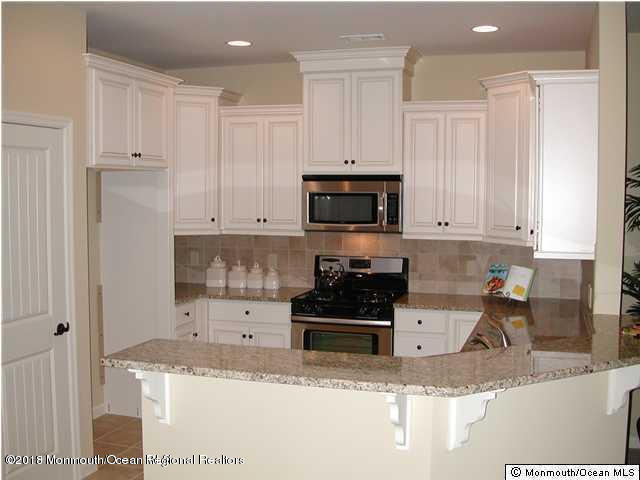 222 Bridge Avenue Red Bank, NJ 07701 - Photo 3 of 11 a kitchen with granite countertop white cabinets and stainless steel appliances