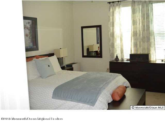 222 Bridge Avenue Red Bank, NJ 07701 - Photo 5 of 11 a bed sitting in a bedroom next to a window