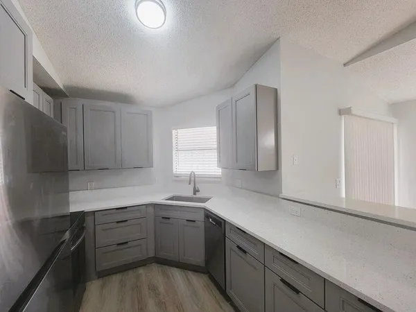 a kitchen with a sink dishwasher a stove and a refrigerator