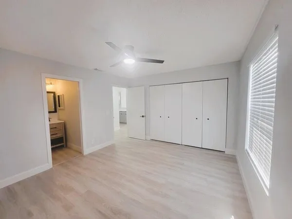 a view of empty room with wooden floor and cabinet