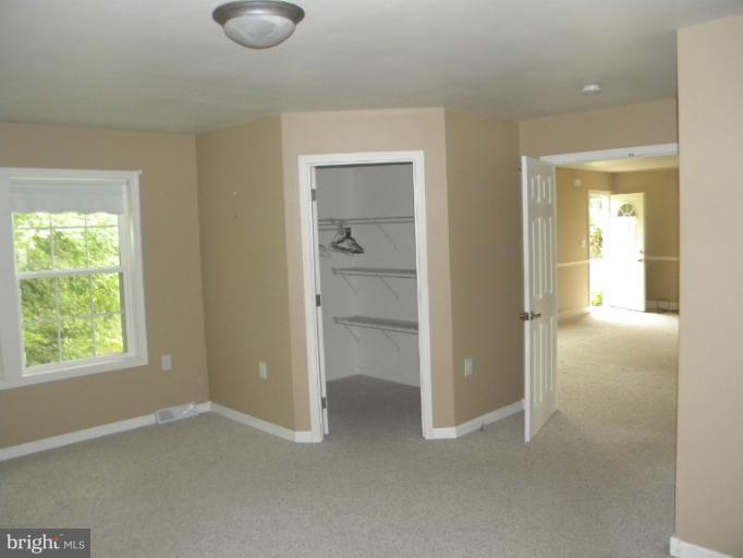 6125 Timber Ridge Road Berkeley Springs, WV 25411 - Photo 12 of 24 a view of an empty room with closet and a window