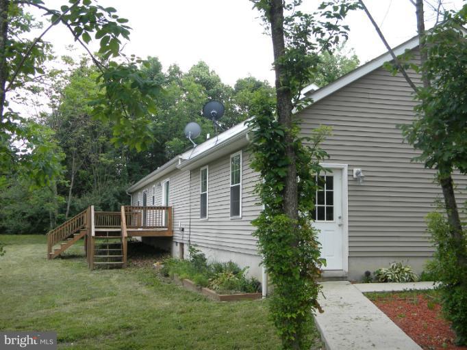 6125 Timber Ridge Road Berkeley Springs, WV 25411 - Photo 17 of 24 a view of a house with a yard