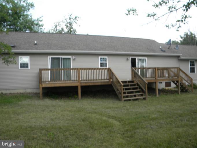 6125 Timber Ridge Road Berkeley Springs, WV 25411 - Photo 19 of 24 a view of a house with a yard and deck