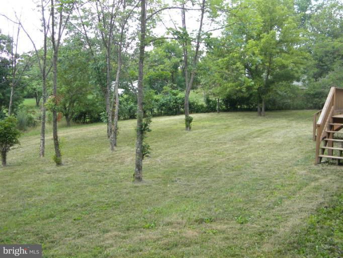 6125 Timber Ridge Road Berkeley Springs, WV 25411 - Photo 20 of 24 a backyard of a house with lots of green space