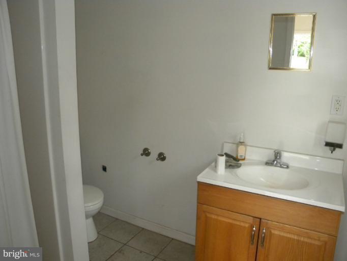 6125 Timber Ridge Road Berkeley Springs, WV 25411 - Photo 24 of 24 a bathroom with a sink toilet and vanity
