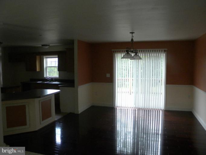 6125 Timber Ridge Road Berkeley Springs, WV 25411 - Photo 6 of 24 a kitchen with stainless steel appliances granite countertop a stove a sink and a dishwasher
