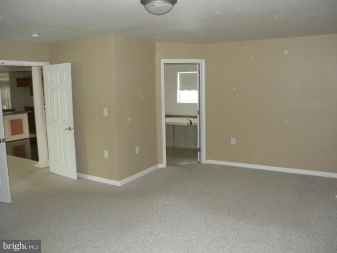 6125 Timber Ridge Road Berkeley Springs, WV 25411 - Photo 9 of 24 an empty room with closet and a bathroom