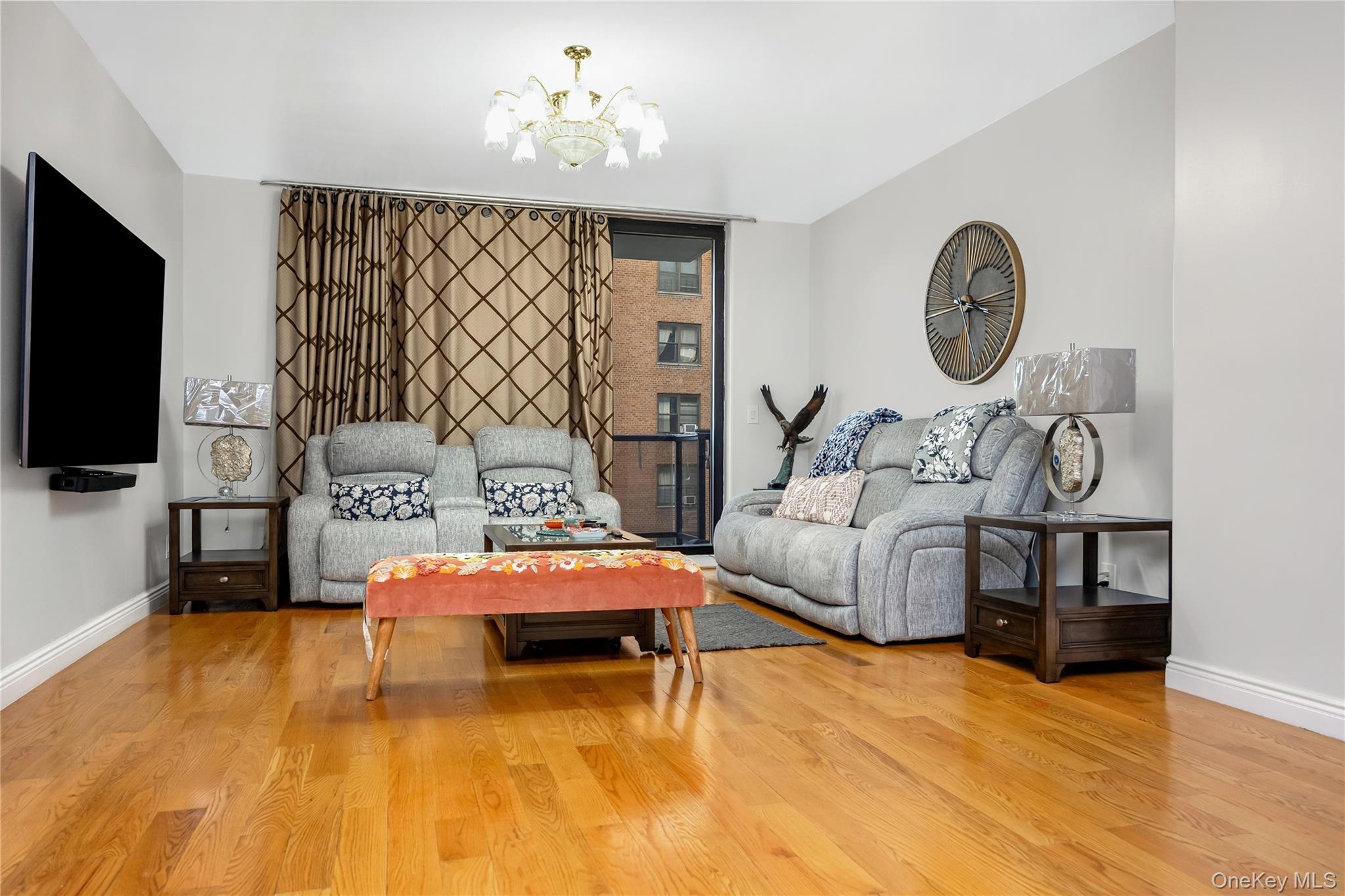 63-36 99th Street, Unit 4F Queens, NY 11374 - Photo 11 of 21 a bedroom with furniture and a flat screen tv