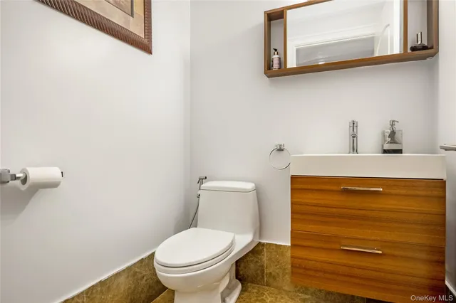 a bedroom with a bed mirror and window