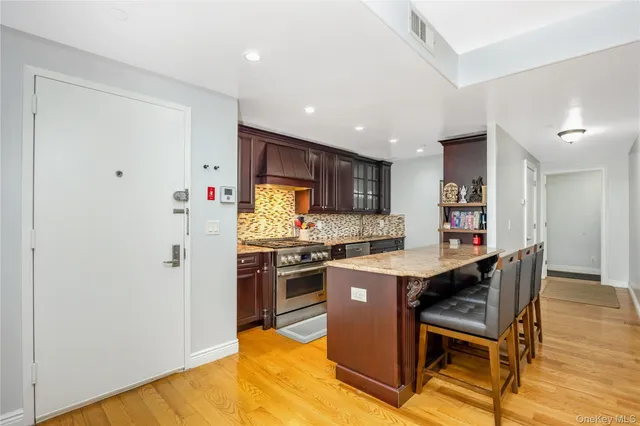 a kitchen with stainless steel appliances granite countertop a stove and a sink