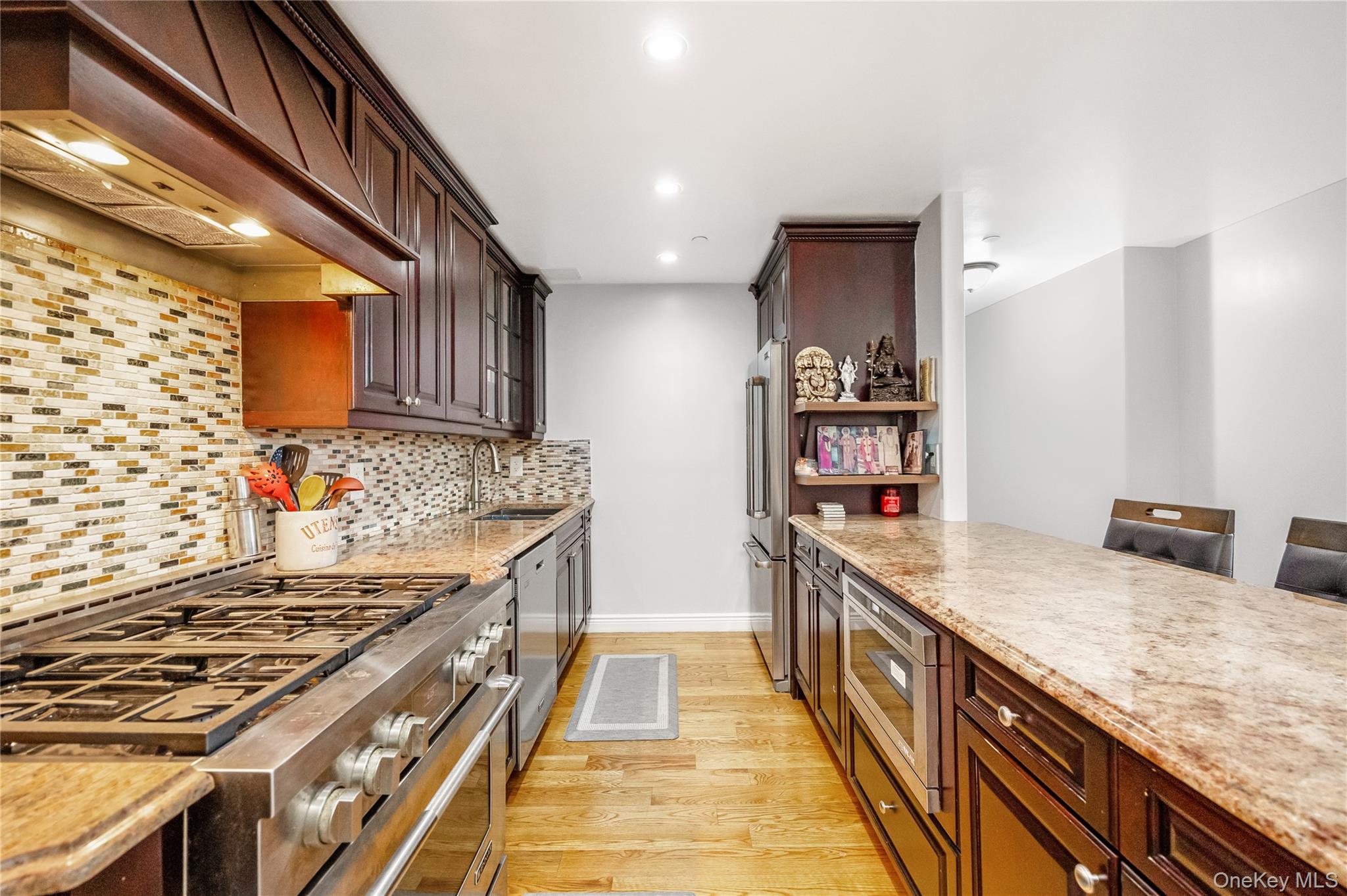 63-36 99th Street, Unit 4F Queens, NY 11374 - Photo 6 of 21 a kitchen with stainless steel appliances granite countertop a stove and a sink