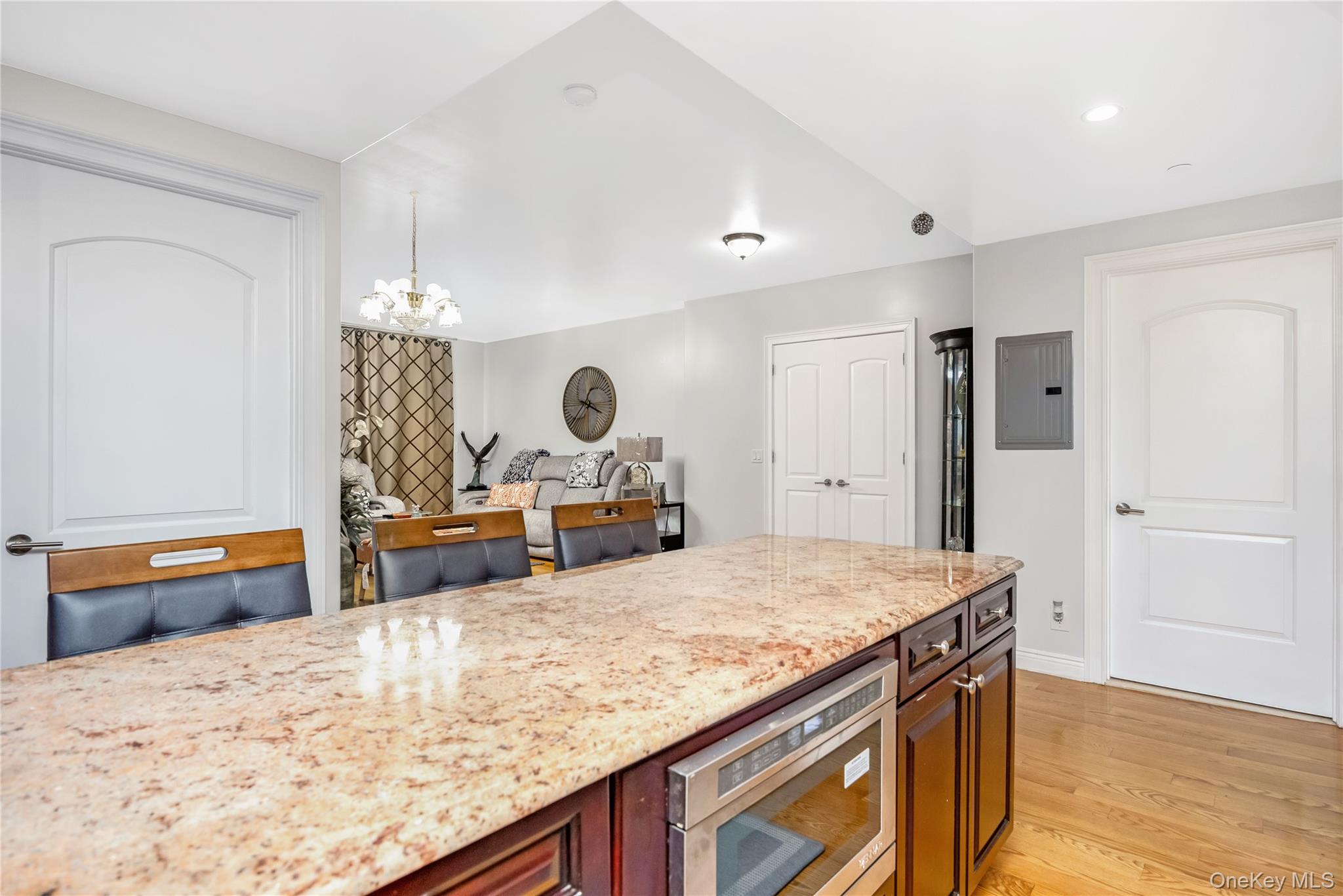 63-36 99th Street, Unit 4F Queens, NY 11374 - Photo 8 of 21 a kitchen with stainless steel appliances kitchen island sink refrigerator and stove