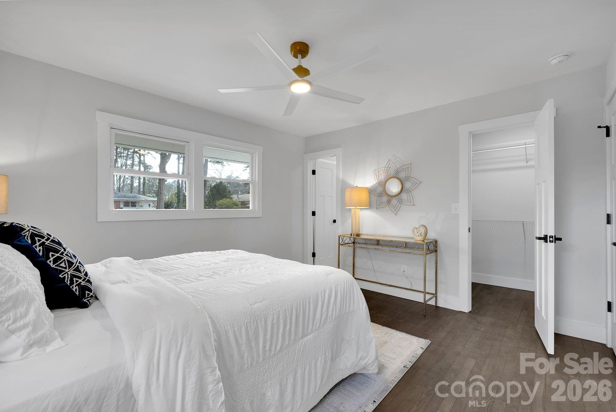 5413 Ruth Drive Charlotte, NC 28215 - Photo 15 of 29 a bedroom with a large bed and a chandelier