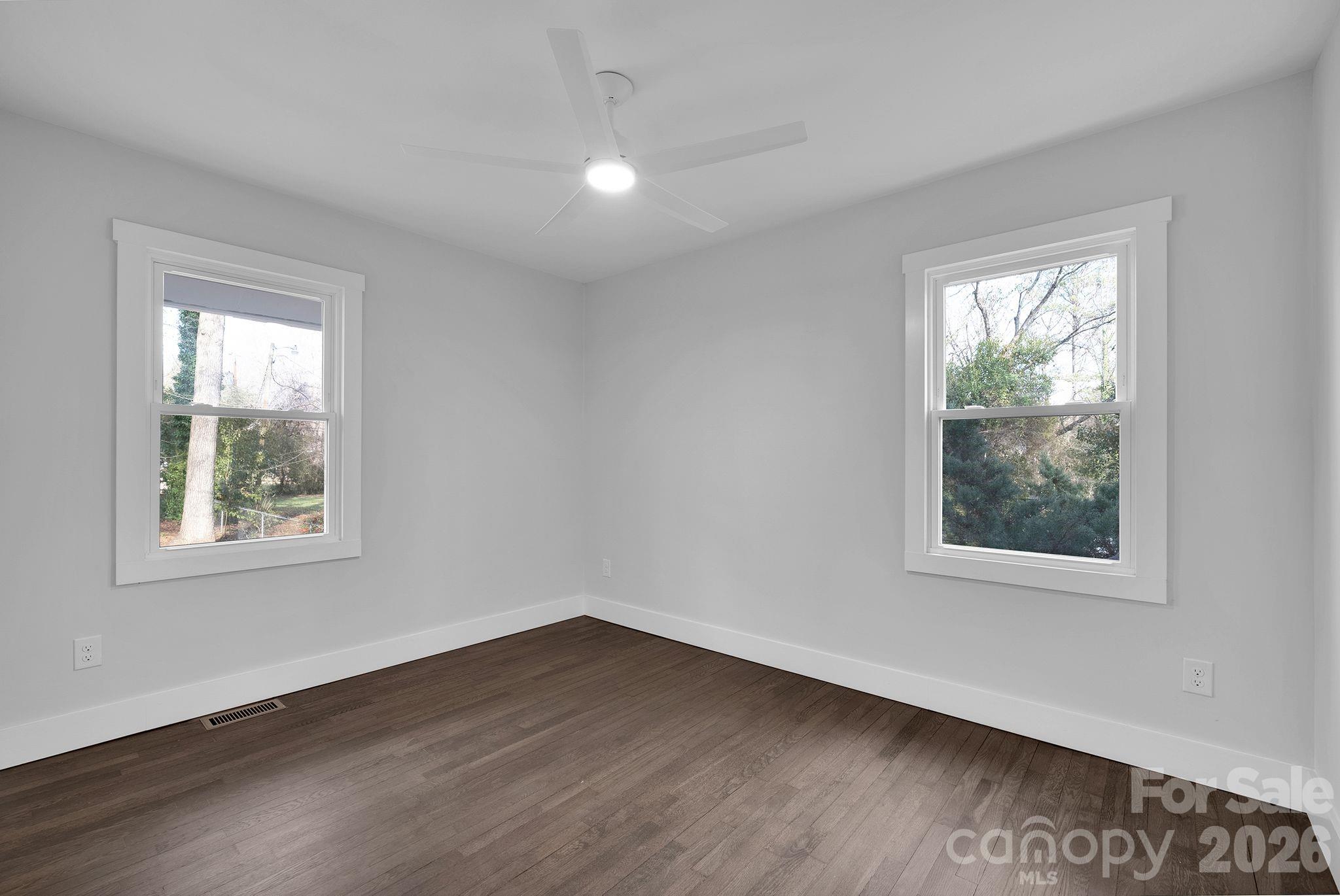 5413 Ruth Drive Charlotte, NC 28215 - Photo 21 of 29 an empty room with wooden floor and windows