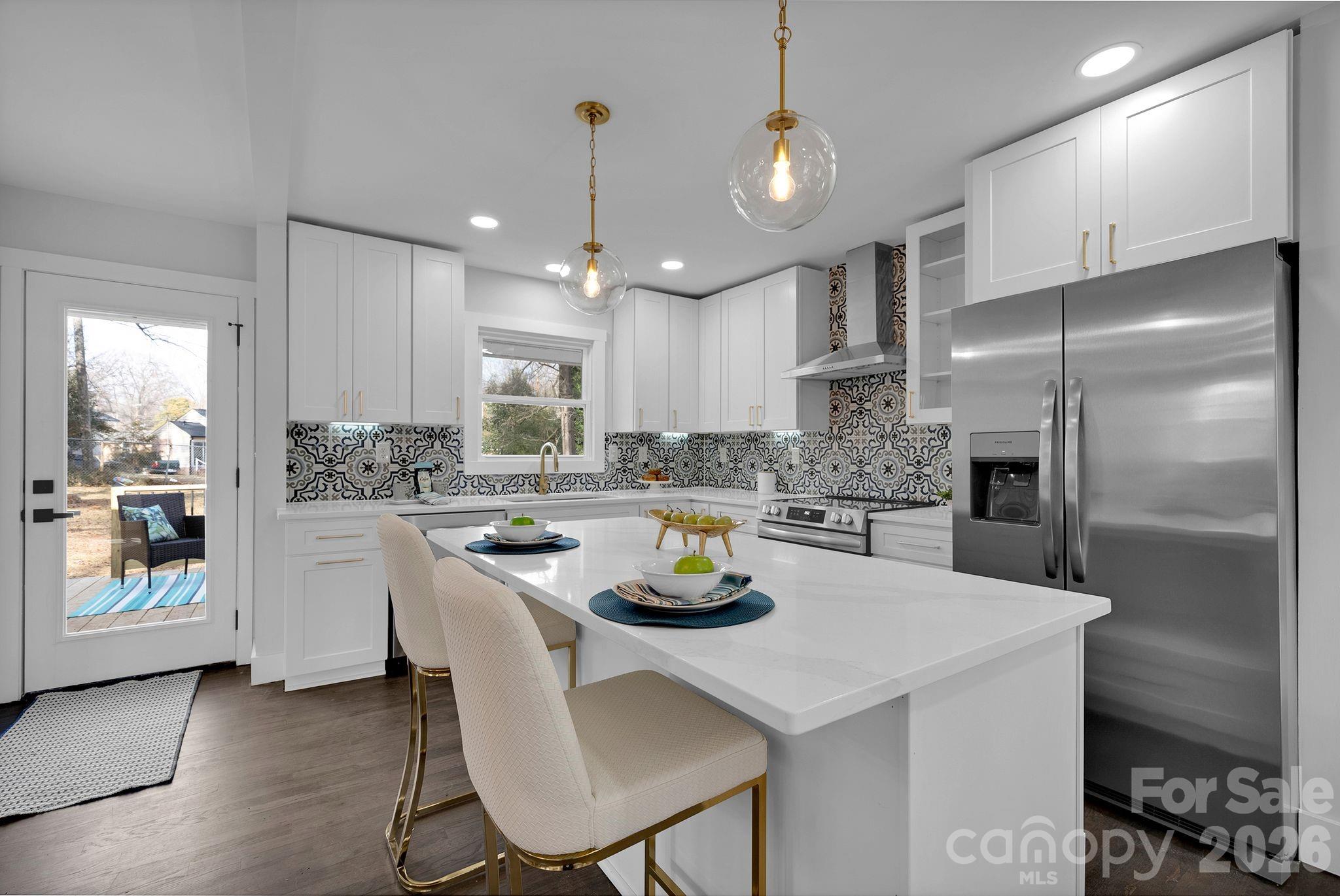 5413 Ruth Drive Charlotte, NC 28215 - Photo 7 of 29 a kitchen with white cabinets and stainless steel appliances