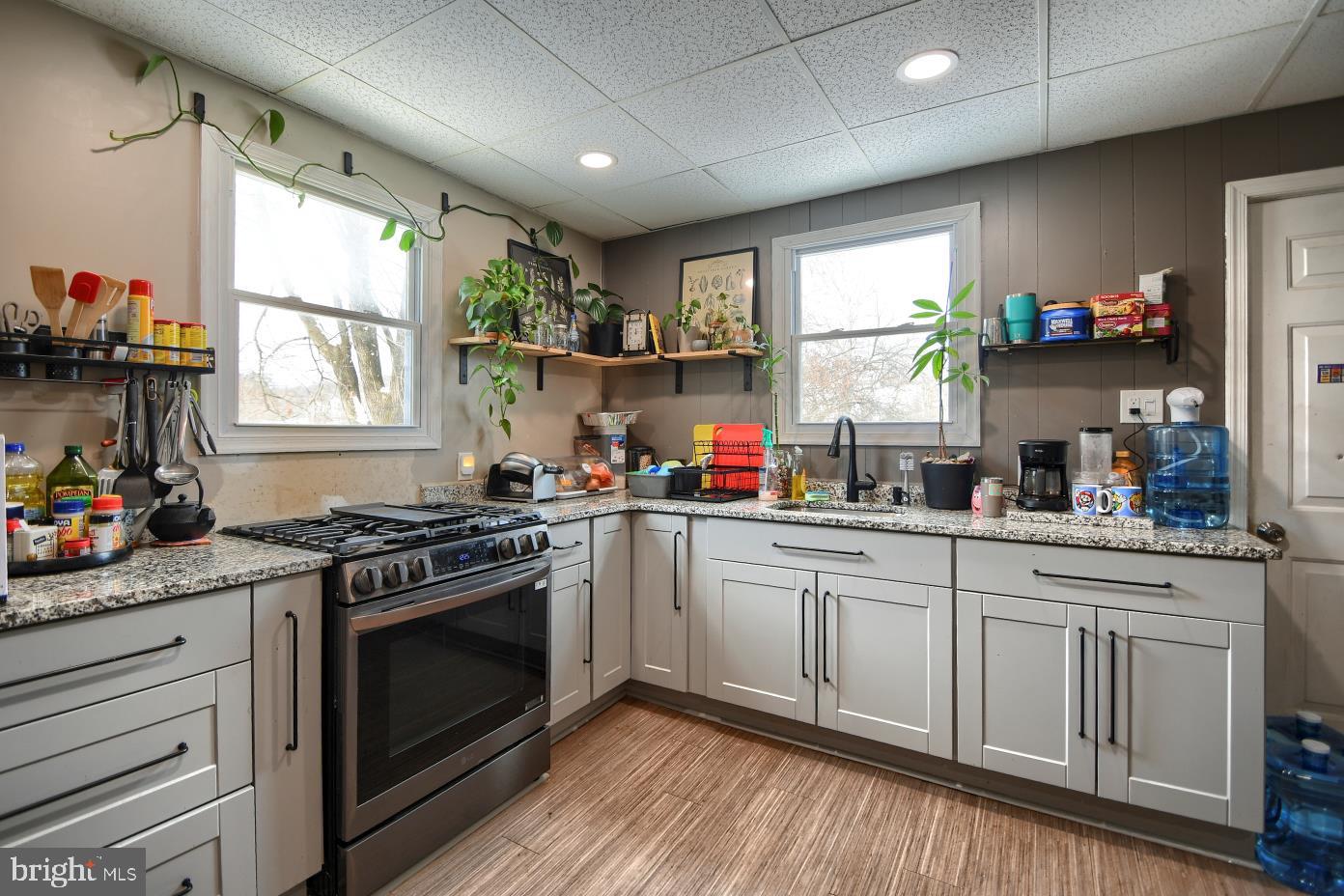 1251 Kimberton Road Chester Springs, PA 19425 - Photo 13 of 31 a kitchen with granite countertop cabinets stainless steel appliances a sink and a large window