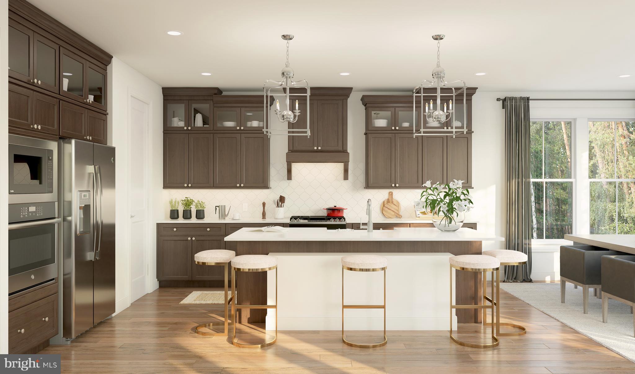 843 Merlin Drive Middletown, DE 19709 - Photo 6 of 16 a kitchen with a table chairs refrigerator and cabinets