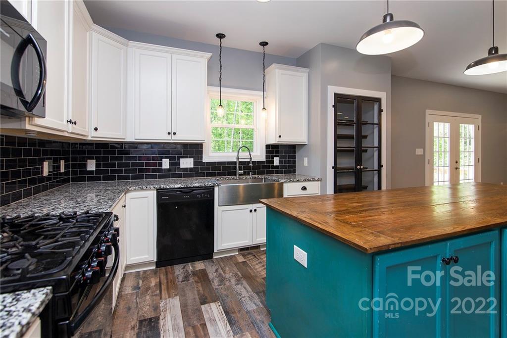 345 Lm Overcash Road Salisbury, NC 28146 - Photo 12 of 23 a kitchen with stainless steel appliances granite countertop a stove a sink and a microwave
