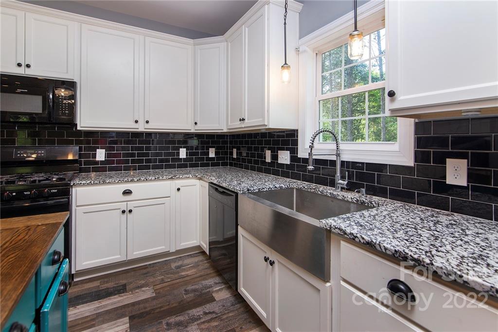 345 Lm Overcash Road Salisbury, NC 28146 - Photo 13 of 23 a kitchen with granite countertop a sink and cabinets