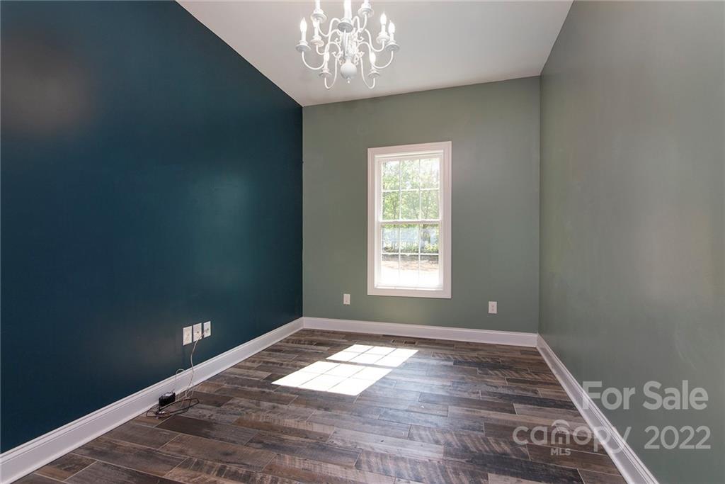 345 Lm Overcash Road Salisbury, NC 28146 - Photo 14 of 23 an empty room with wooden floor and windows
