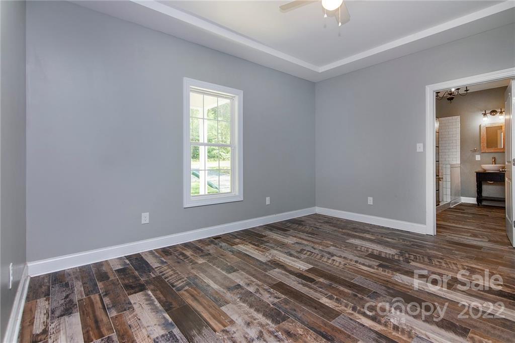 345 Lm Overcash Road Salisbury, NC 28146 - Photo 17 of 23 a view of empty room with wooden floor and fan