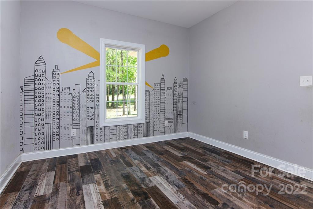 345 Lm Overcash Road Salisbury, NC 28146 - Photo 19 of 23 a view of an empty room with a window and wooden floor
