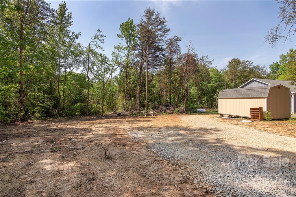 345 Lm Overcash Road Salisbury, NC 28146 - Photo 22 of 23 a big yard with road and trees