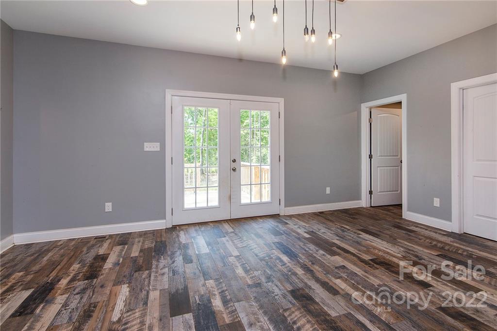 345 Lm Overcash Road Salisbury, NC 28146 - Photo 9 of 23 a view of an empty room with wooden floor and a window