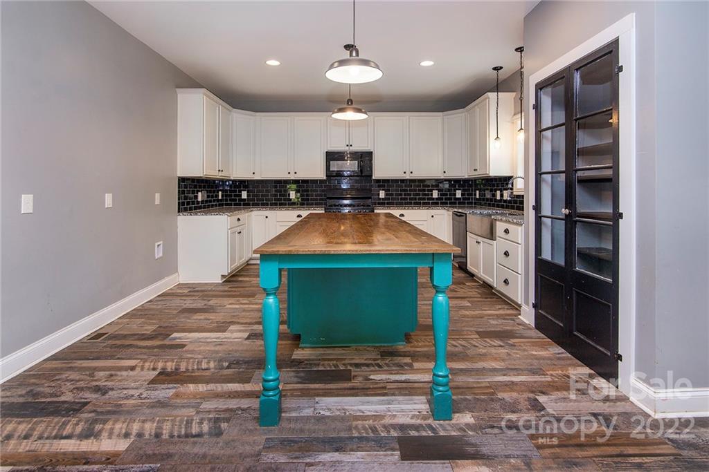 345 Lm Overcash Road Salisbury, NC 28146 - Photo 10 of 23 a kitchen with stainless steel appliances kitchen island granite countertop a refrigerator a stove and a sink