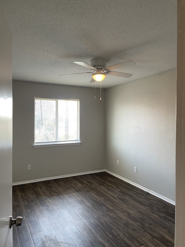 8401 Colony Loop Drive, Unit D Austin, TX 78724 - Photo 15 of 18 an empty room with wooden floor and windows