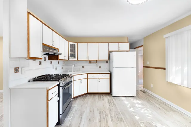 a kitchen with a white cabinets and white appliances
