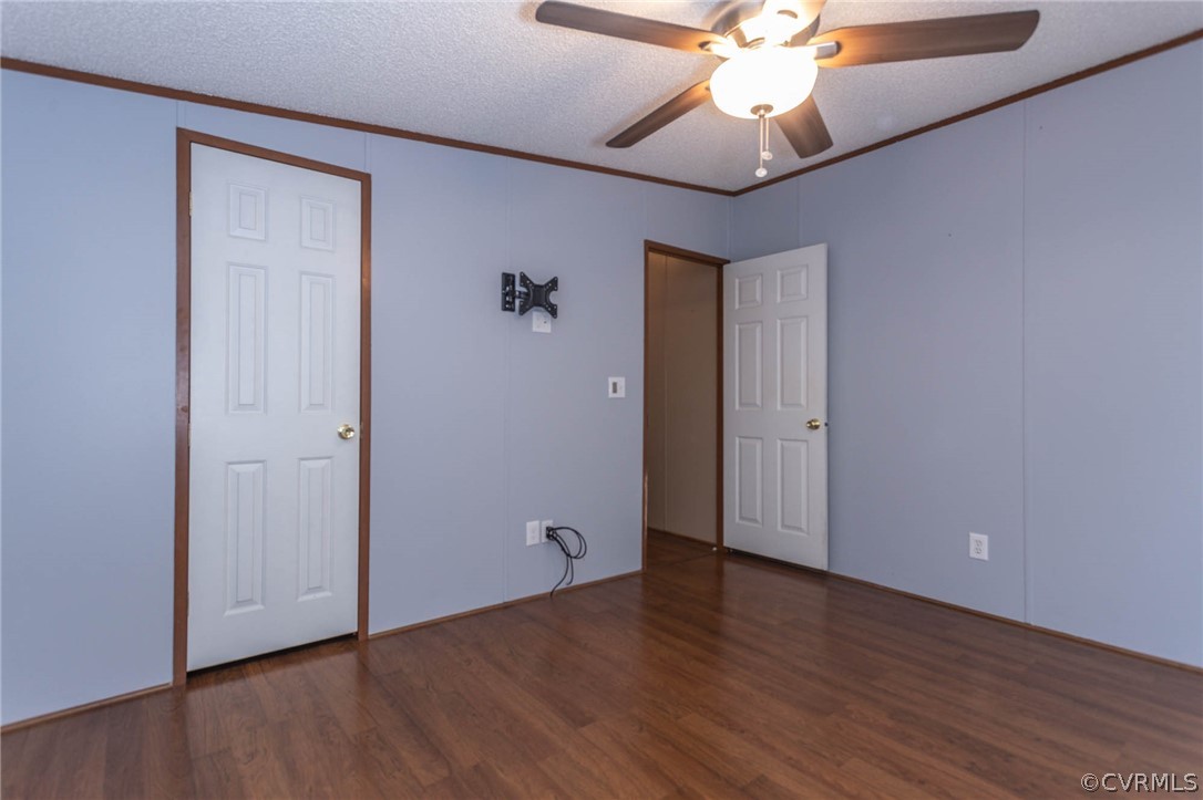 6400 Hair Road Disputanta, VA 23842 - Photo 24 of 30 an empty room with wooden floor fan and windows