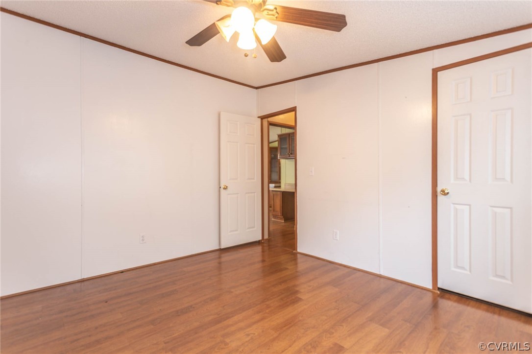 6400 Hair Road Disputanta, VA 23842 - Photo 28 of 30 an empty room with wooden floor chandelier and closet