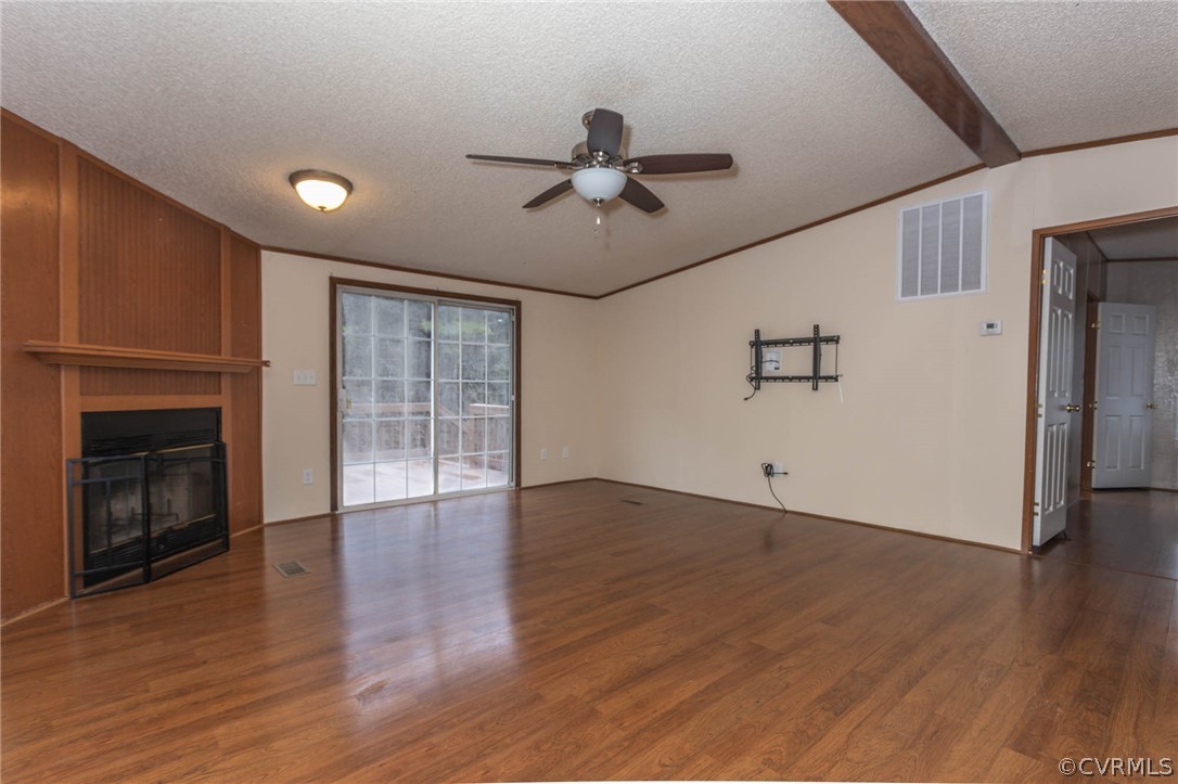 6400 Hair Road Disputanta, VA 23842 - Photo 4 of 30 a view of an empty room with wooden floor fireplace and a window