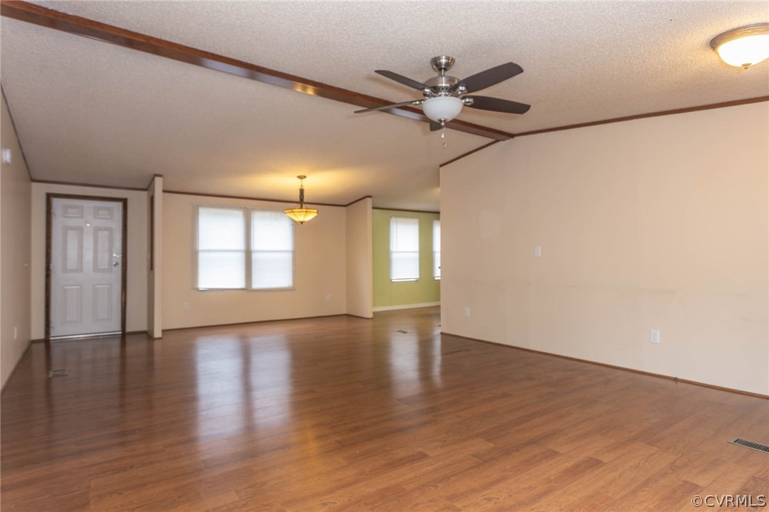 6400 Hair Road Disputanta, VA 23842 - Photo 5 of 30 an empty room with wooden floor fan and windows