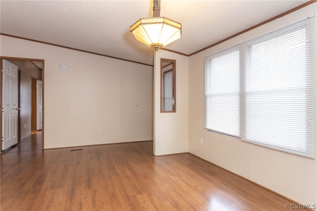 6400 Hair Road Disputanta, VA 23842 - Photo 6 of 30 a view of empty room with wooden floor and fan