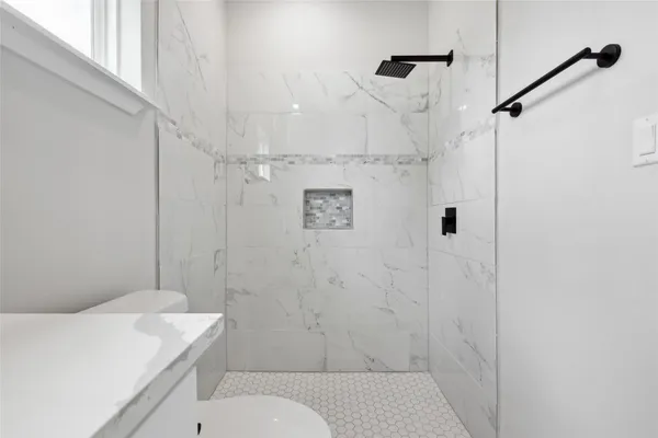 a bathroom with a sink toilet and shower